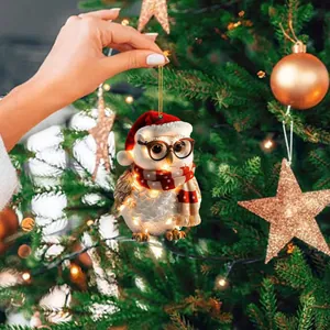 Detailed view of a cute owl Christmas ornament with internal LED lights on a tree