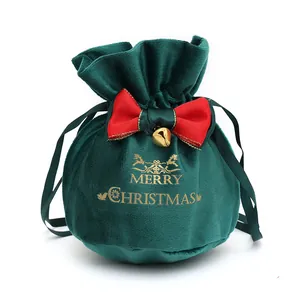 Elegant green velvet Christmas drawstring gift bag with red bow and golden bell