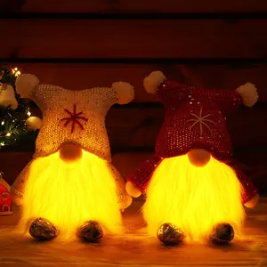 Decorative glowing Christmas gnomes with red and white sequined hats and warm LED light