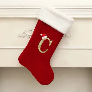 Large red velvet Christmas stocking featuring a golden glitter letter C and Santa hat