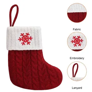 Knitted Christmas stocking with red snowflake embroidery and hanging lanyard