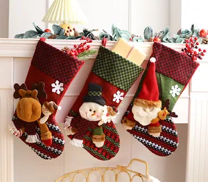 Three festive 3D Christmas stockings with moose, snowman, and Santa motifs on a mantle