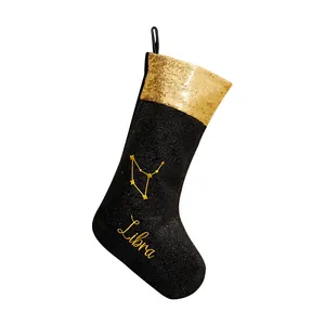 Calza di Natale Bilancia in paillettes nero e oro per decorazioni natalizie.