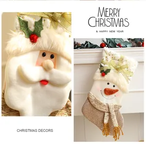 Close-up detail of Santa and Snowman plush Christmas stockings for holiday decor