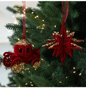 Detail view of red flocked Christmas carriage and snowflake ornaments on a pine tree.