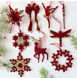 Detailed macro view of assorted red flocked Christmas ornaments decorated with gold sequins