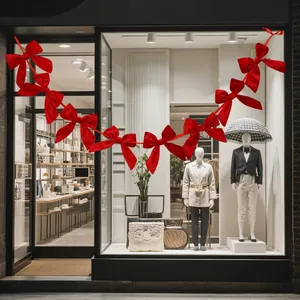 Red bow garland hanging decoration for Christmas window display and festive atmosphere