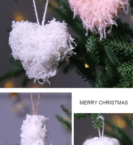 Detailed view of white and pink heart-shaped fuzzy feather ornaments on Christmas tree