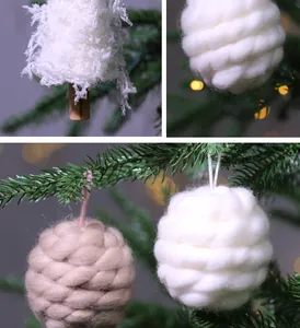 Detailed view of white feather tree and hand-knitted yarn ball Christmas ornaments