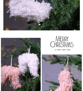 Close-up of white and pink fuzzy feather ornaments hanging on a Christmas tree.