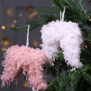 Fluffy feather heart ornaments in white and pink hanging on a festive Christmas tree