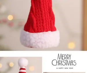 Nahaufnahme der weichen Strickstruktur einer roten Mini-Weihnachtsmütze als Deko