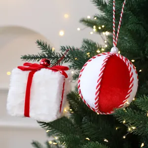 Coffret cadeau en peluche et boules de Noël en velours rouge sur un sapin festif