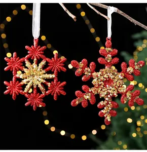 Detail of red acrylic snowflake ornaments with gold sequins for Christmas trees