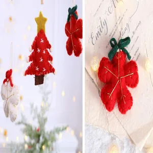 Close-up of red felt Christmas tree and snowflake ornaments with golden thread details