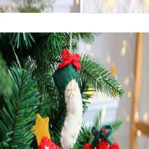 Close-up of a handmade green and white felt Christmas stocking ornament with gold embroidery