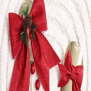 Detailopname van rode glitter kerststrikken met dennenappels voor boomdecoratie.
