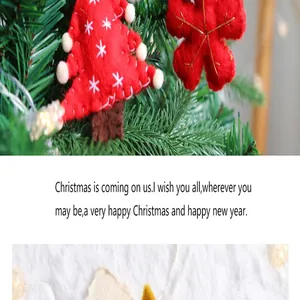 Detail view of handmade red felt Christmas tree and snowflake ornaments on festive pine branches