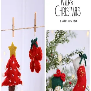 Close-up of red and green Christmas felt ornaments like trees and stockings in festive setting.