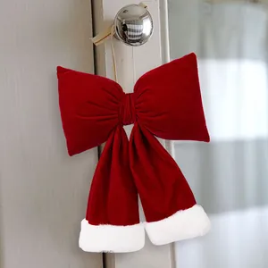 Large red velvet Christmas bow with white plush trim for festive holiday home decoration