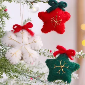 Festive handmade felt Christmas ornaments featuring star and snowflake shapes on a tree