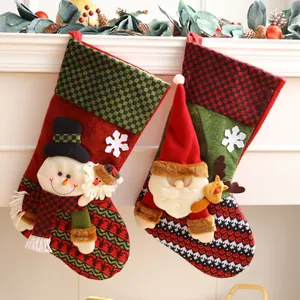 Festive Christmas stockings set featuring Santa and Snowman for mantel holiday decor.