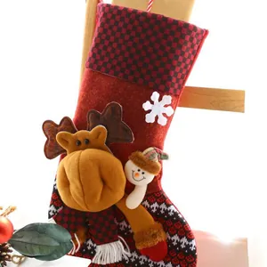 Red checkered Christmas stocking with plush reindeer and snowman character decor