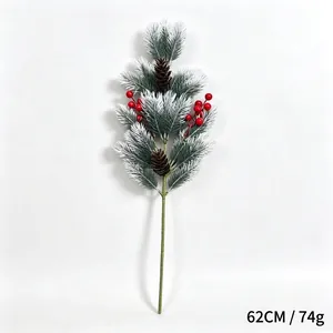 Detailed view of artificial frosted pine branch with red berries and pinecones
