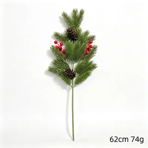 Detailed view of artificial Christmas pine branch with red berries and pine cones