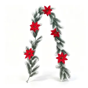 Detailed view of 180cm frosted artificial Christmas pine vine with red poinsettia flowers