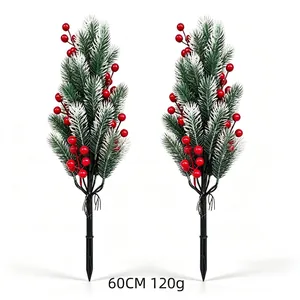 Detailed close-up of frosted pine needles and red berries on Christmas garden picks