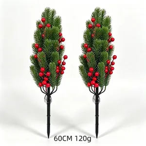 Close-up of two artificial Christmas garden stakes with pine needles and red berries
