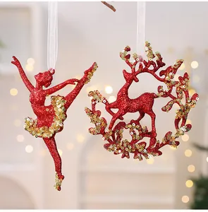 Close-up of red glitter Christmas ornaments in ballerina and reindeer shapes with sequins