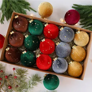 Dettaglio di palline di Natale in velluto colorato con stelle dorate in una scatola