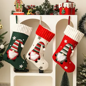Set of three festive Christmas stockings with embroidered gnome designs in red, green and white