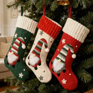 Set of three festive Christmas stockings featuring gnome embroidery and snowflake patterns