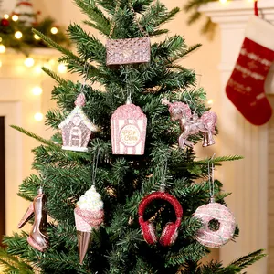 Elegant pink electroplated glitter Christmas ornaments hanging on a festive tree decor.