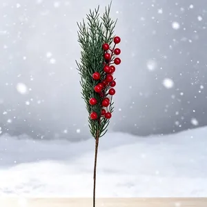 Vibrant artificial Christmas pine branch with red berries for festive holiday home decor