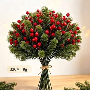 Beautiful artificial Christmas pine branches bouquet with red berries for festive home decor