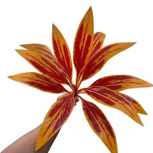 Hojas de Cordyline artificiales en naranja y rojo para decoración de interiores.