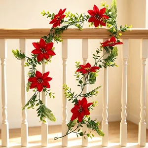 Artificial Christmas garland with red poinsettias and green eucalyptus leaves for home deco
