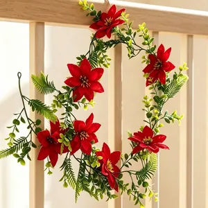 Artificial Christmas poinsettia and eucalyptus leaf garland for home wall decoration.
