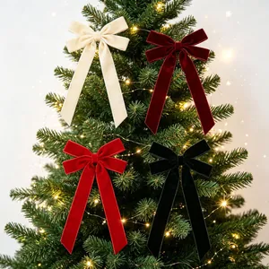 Four elegant velvet Christmas tree bow ornaments in festive colors with long ribbons