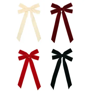 Set of four velvet Christmas tree bow ornaments in cream, burgundy, red and dark green.