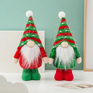 Pair of festive Christmas gnomes with sequined bodies and striped knit hats for decor