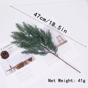 Close-up detail of realistic artificial green pine branch for Christmas decoration