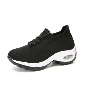 Side view detail of women's black knitted rocking sneakers with white air cushioned sole