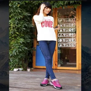 Women's stylish pink outdoor hiking sneakers worn by a model in a natural garden setting.