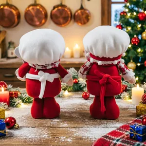 Festive Christmas chef gnomes plush toys in red and white on a snowy winter wooden table.