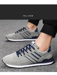 Close-up of grey breathable men's running shoes with blue stripes on a model